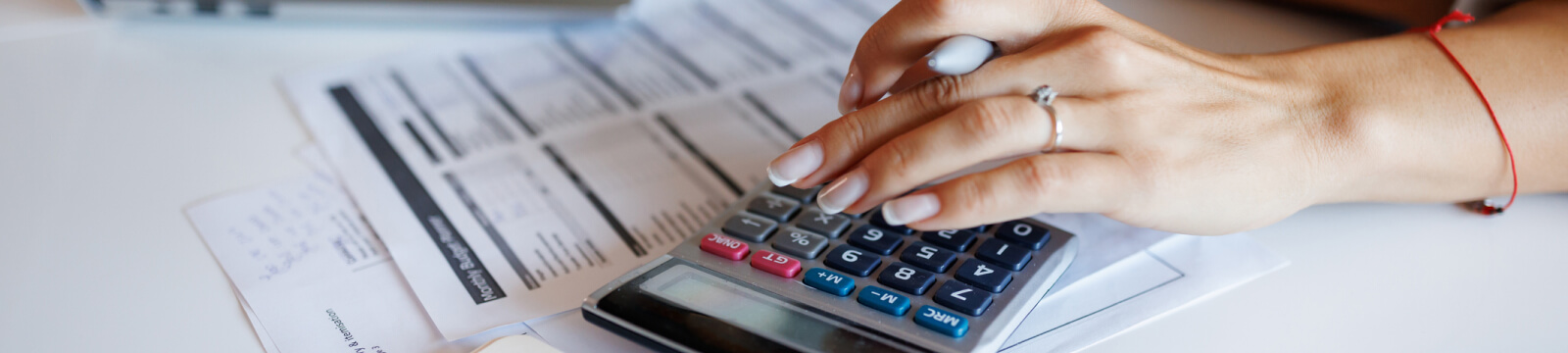 Close-up of hands using a calculator