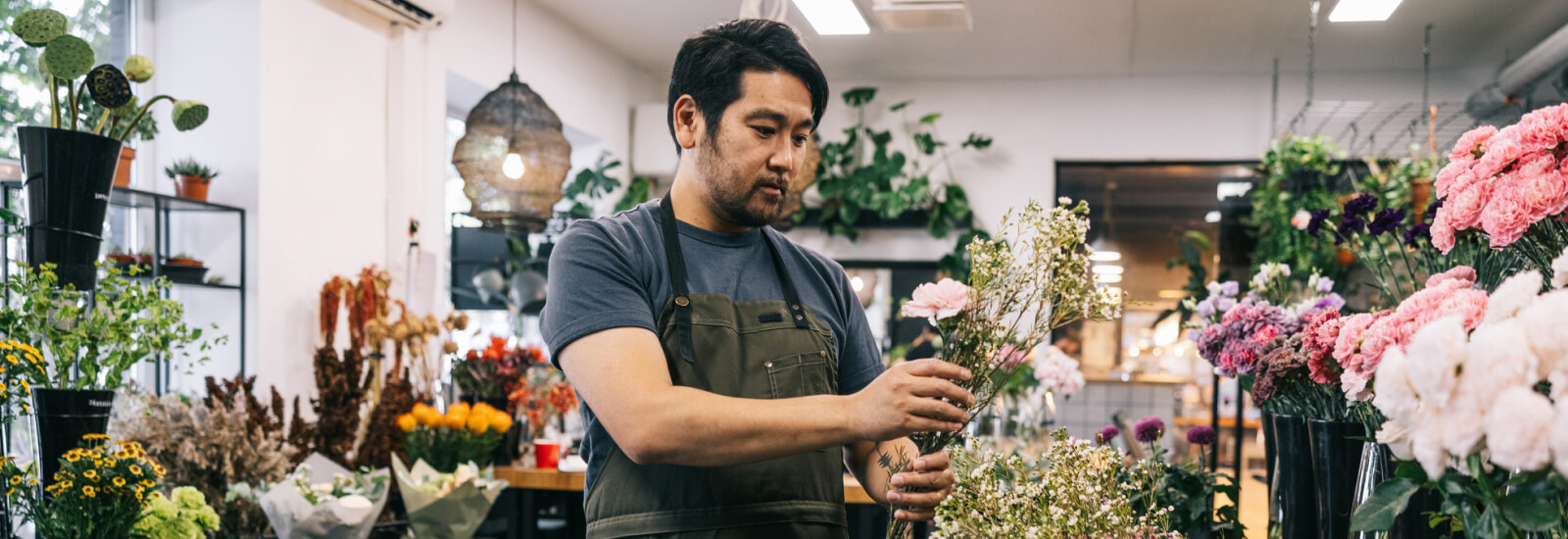 A man arranging flowers in a florist shop